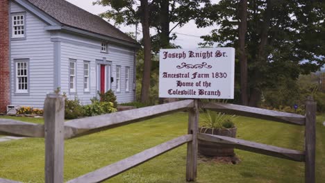 sign and full wide shot of the original home of the knights, joseph sr and newel knight and where the first branch of the church of christ, mormons located in colesville, new york near bainbridge