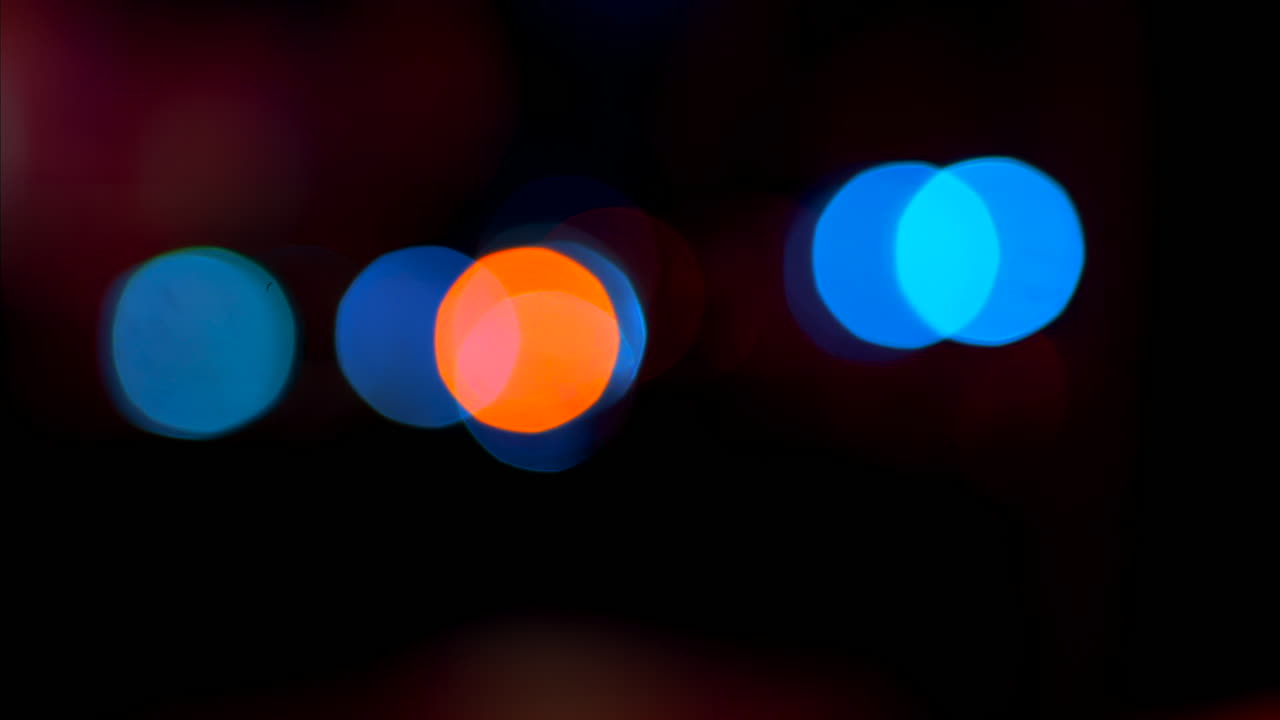 Abstract display of out-of-focus, colourful lights in a dark setting