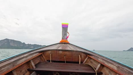 boat travels through ocean towards distant islands