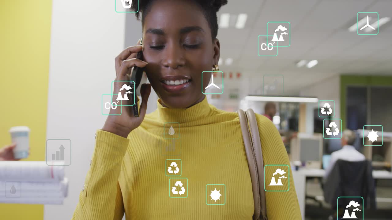 Office worker raising smartphone initiating sustainability call with green metrics icons floating