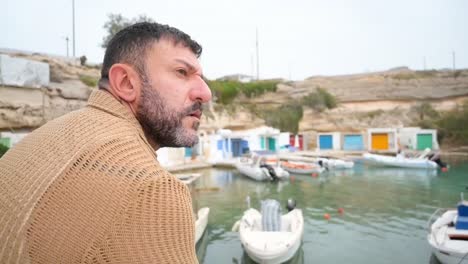 man looking at the fishing village of mandrakia