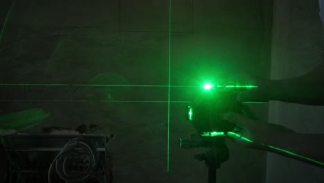 precision in construction: a worker uses a laser level to project horizontal and vertical beams, ensuring accurate alignment during the build or renovation process