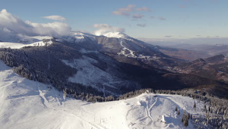 sweeping aerial panorama of snow-capped mountain terrain