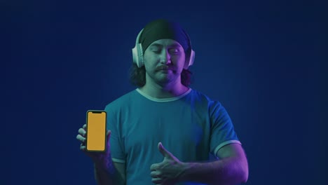 man listening to music with headphones and a phone
