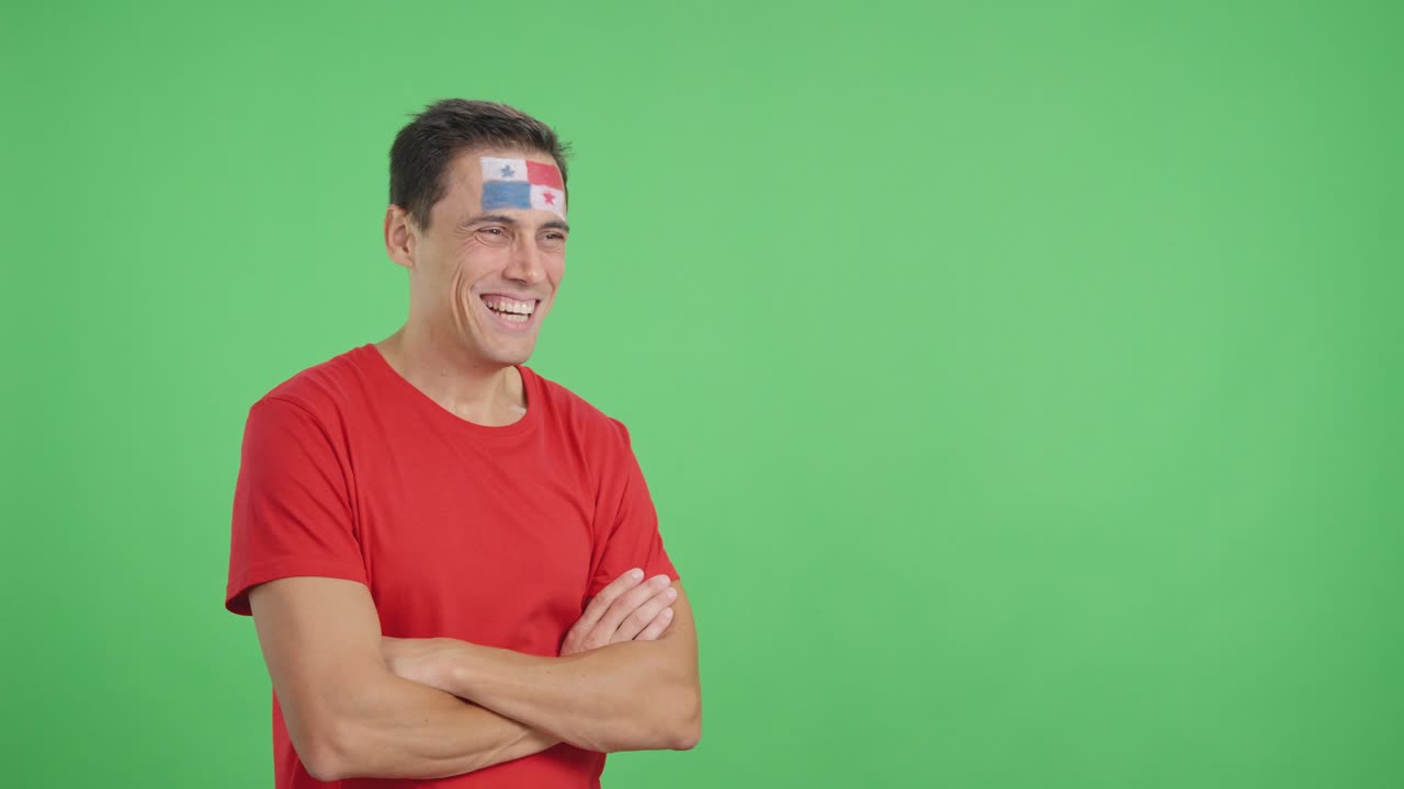 Happy man with panamanian flag painted on face looking away