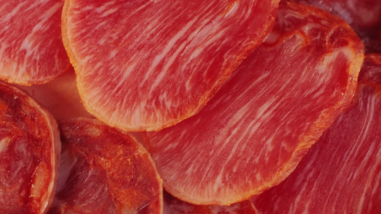 Mix of spanish pork sausages, Cutting board of appetizing catalonian snack - fuet, jamon, chorizo, olives, supermarket tapas food in spain, traditional cuisine.