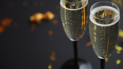 Two-glasses-full-of-sparkling-champagne-wine-with-golden-decoration