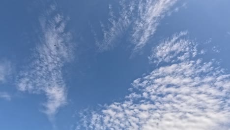 time-lapse of clouds moving across a blue sky.