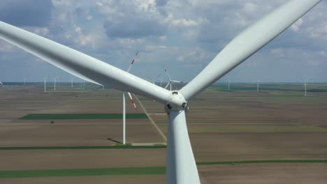 aerial view of several windmills, wind generators, turbines, producing renewable clean energy by converting kinetic energy