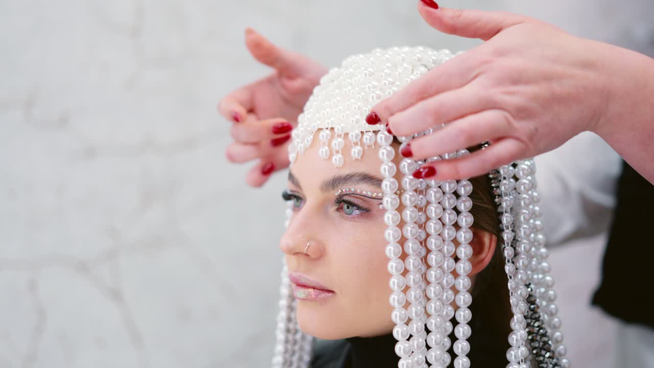 Woman wearing an elaborate pearl and bead headdress