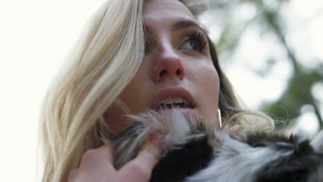 pretty young blonde woman wearing a fur jacket posing