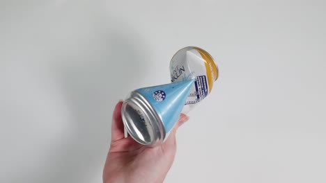 sequence of a hand turning a beverage can