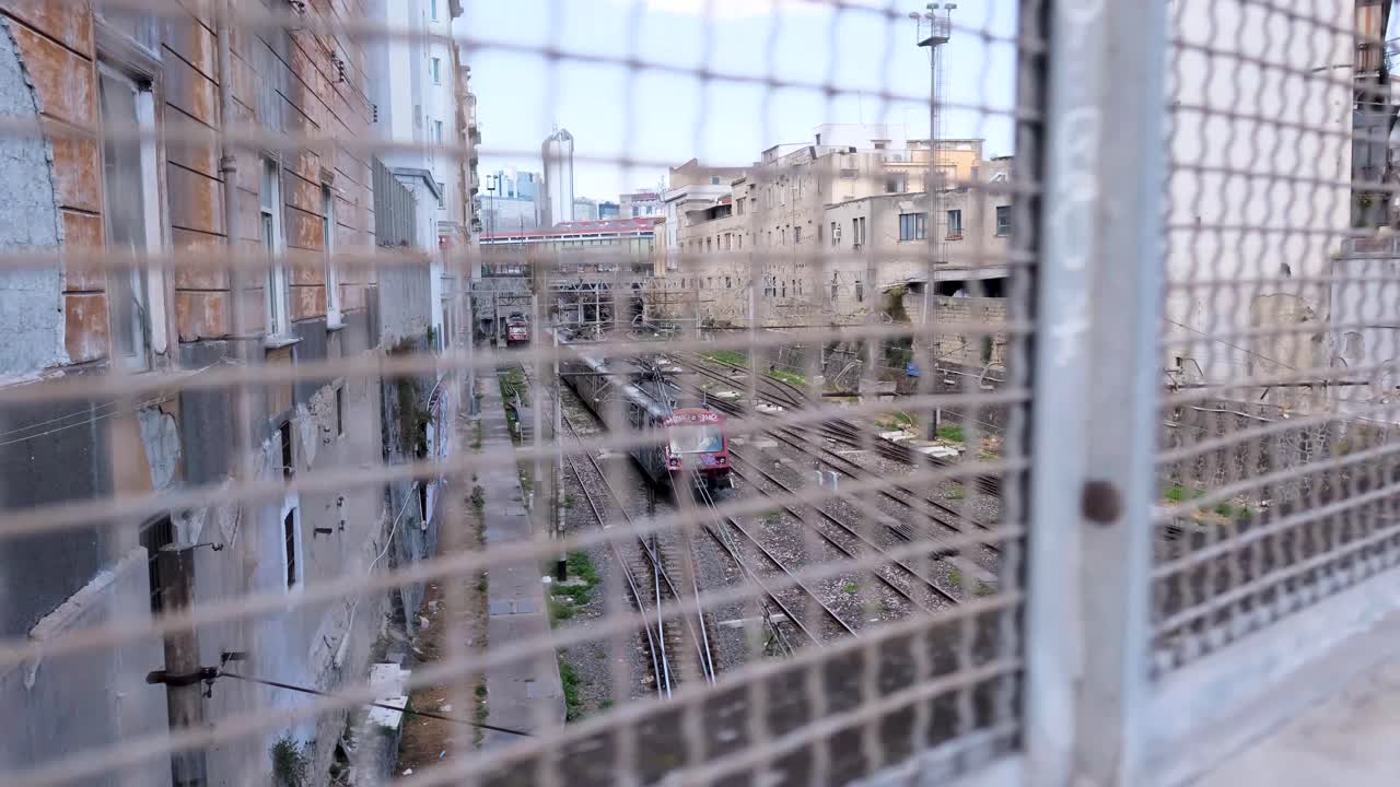 Subway Train with Graffiti Pulls Away as Camera Tracks Right in Slow Motion