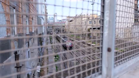 subway train with graffiti pulls away as camera tracks right in slow motion