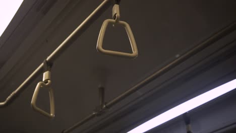 hanging-handles-in-a-moving-train-metro-in-singapore