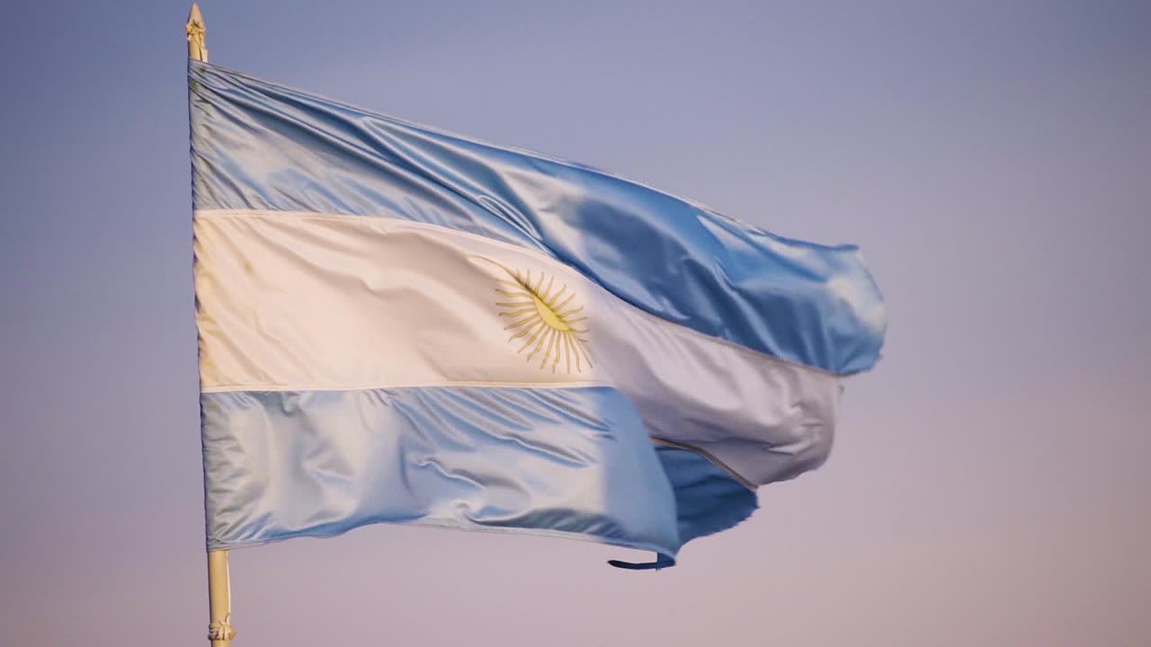Flag Of Argentina Waving With The Wind In Blue Sky Background - close up, slow motion