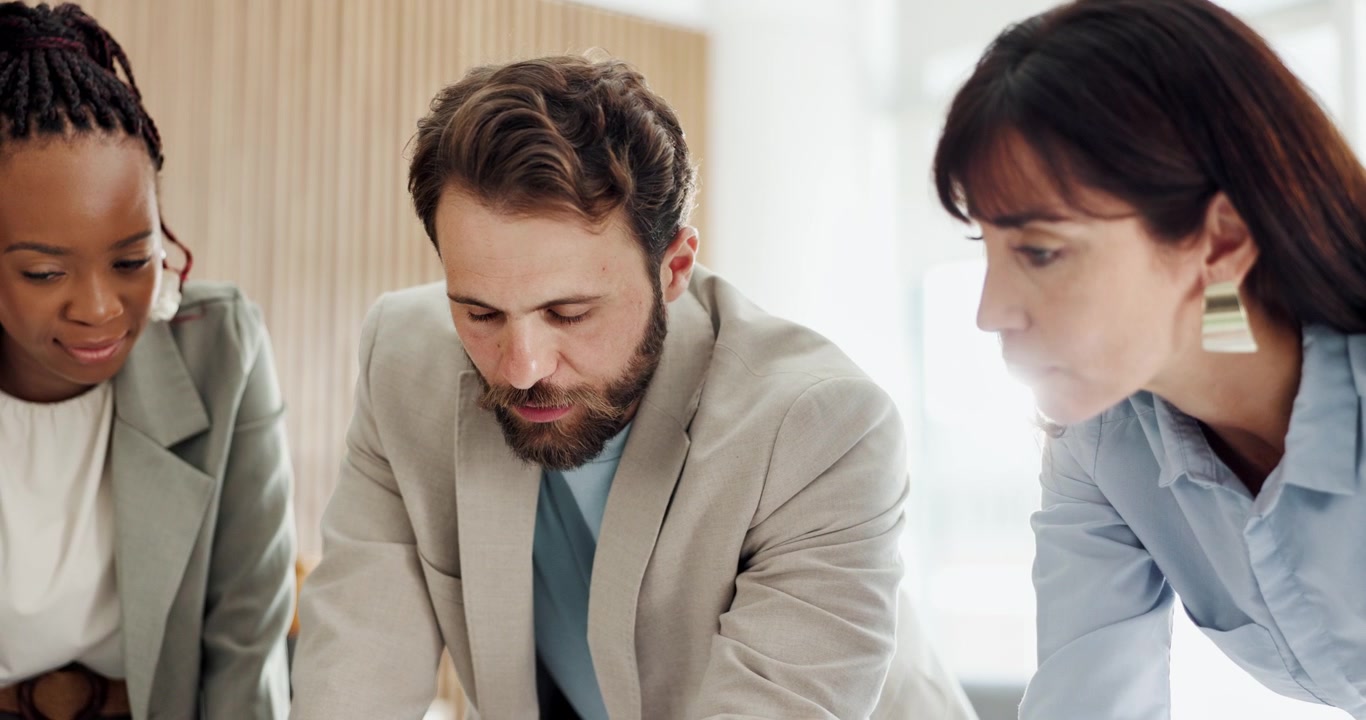Diverse Business Team Collaborating on Project in Modern Office