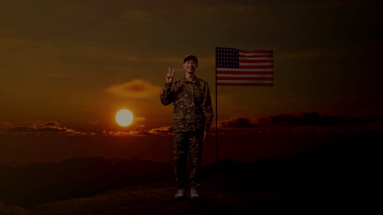 Full Body Of Asian Man Soldier Smiling And Showing Peace Gesture To Camera While Standing With Flag Of The United States, Sunset Time
