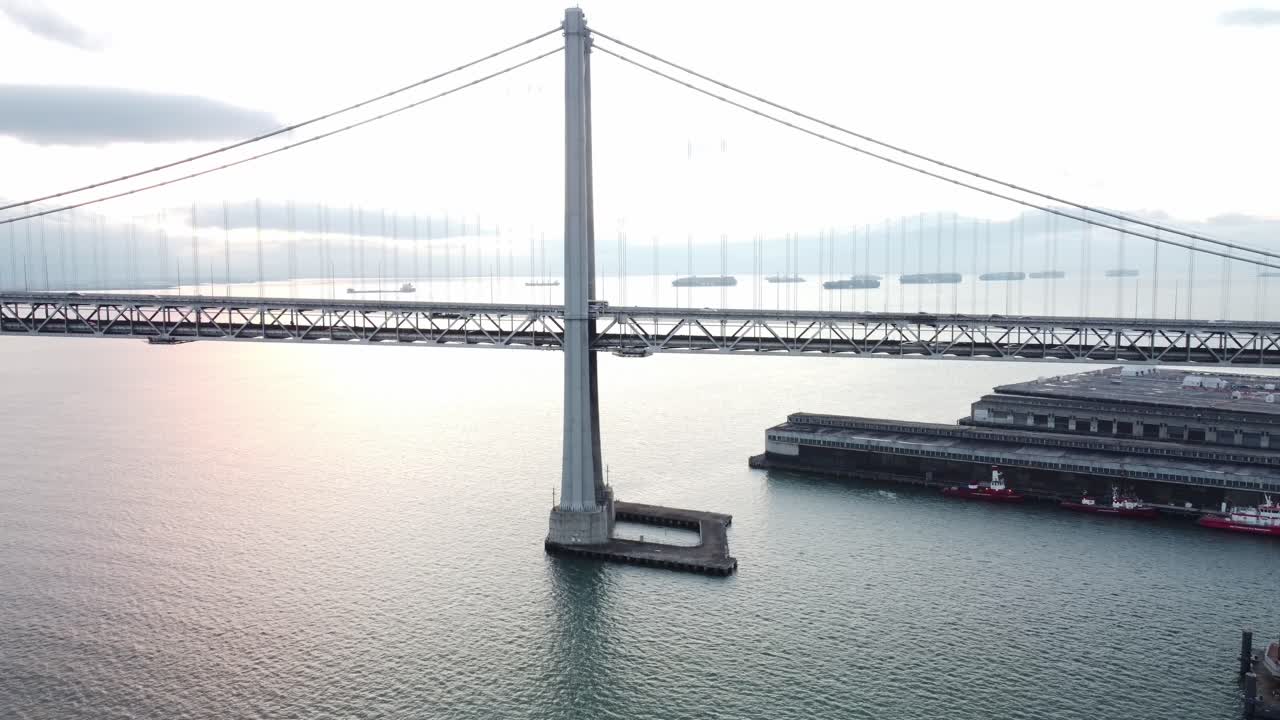 Aerial drone footage captures the Bay Bridge and parts of the Embarcadero in San Francisco, California.