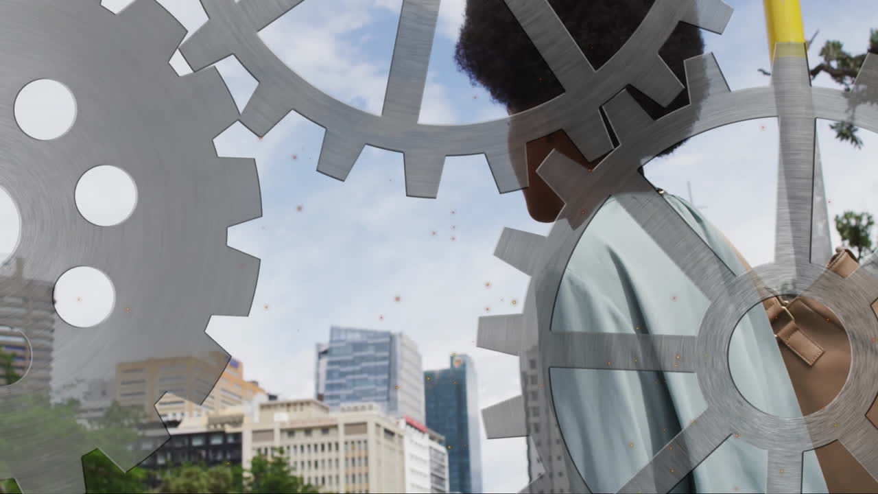 Woman carrying bag walking urban plaza, showing metallic gear cutouts animated with tech charts