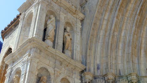 the basilica of santa maria la mayor main facade with carving statues and arched doorway in morella, castellon spain