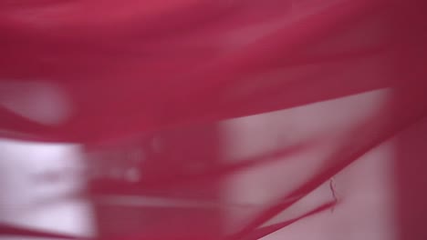 red canvas develops in the wind near the arch for the newlyweds