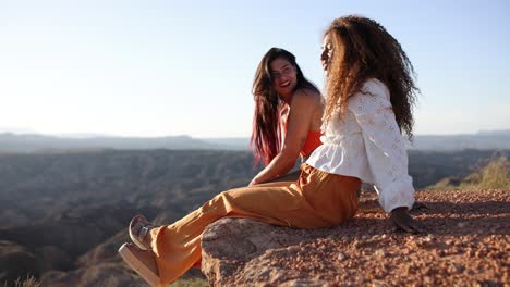 two women enjoying the scenic view from a cliff