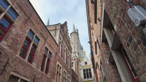 bruges city hall with gothic spires, iconic medieval architecture in historic city center, low angle view