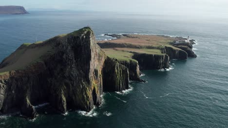 drone panning shot of neist point at isle of skye in scotland on a sunny day