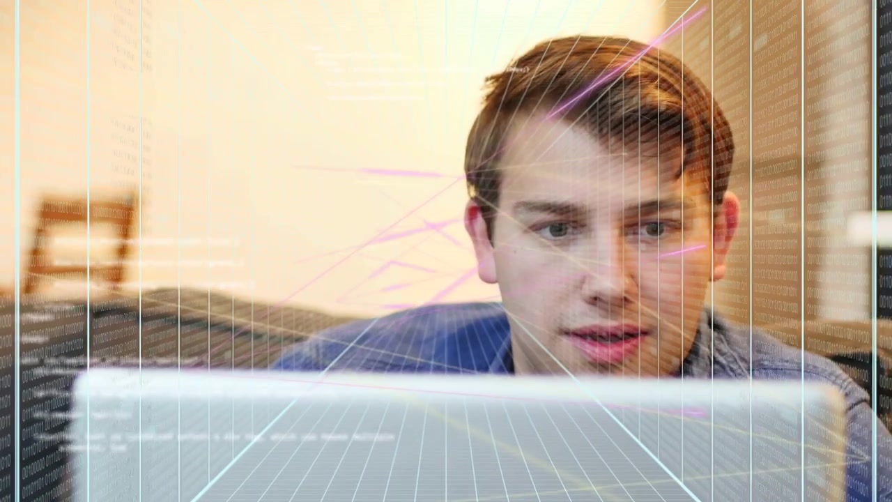 Man on sofa working laptop lowering gaze initiating speaking as grid and pink streaks overlay tech
