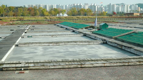 old salt farm at gaetgol ecological park with high-rise buildings in the background in siheung, gyeonggi-do, south korea