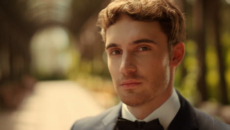 Curious-male-person-waiting-for-ceremony-outdoors