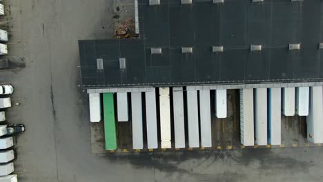 Top down aerial of cargo trailers lined up a distribution center in United States, cargo, shipping, transportation, logistics concept