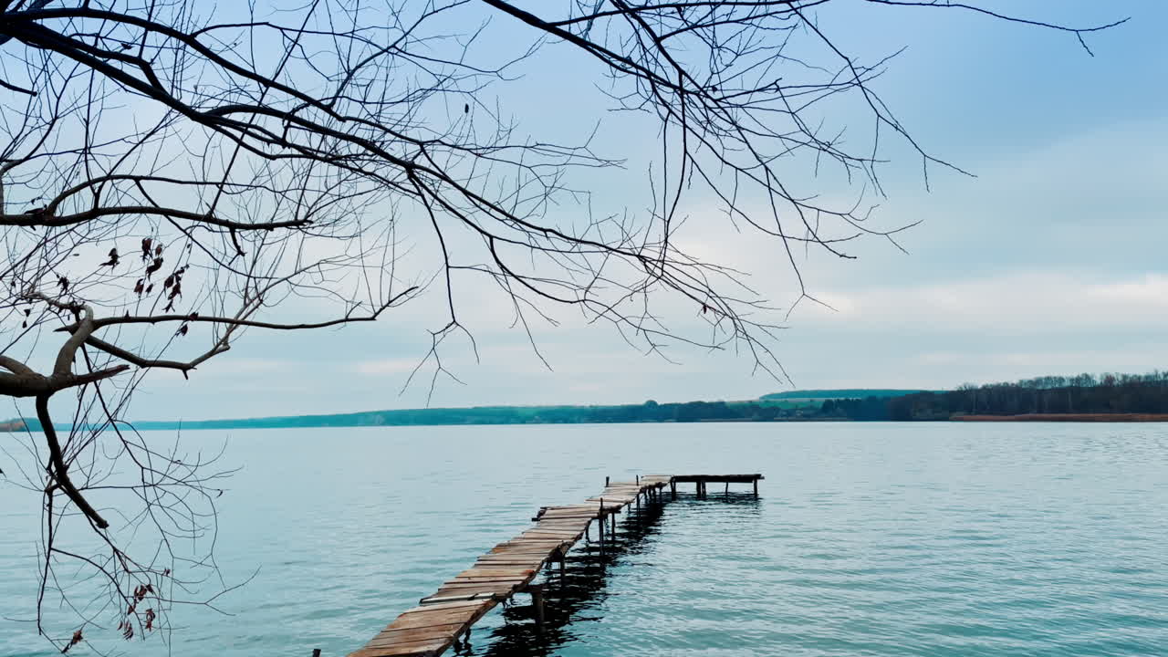 Serene Lakeside Pier on a Cloudy Day