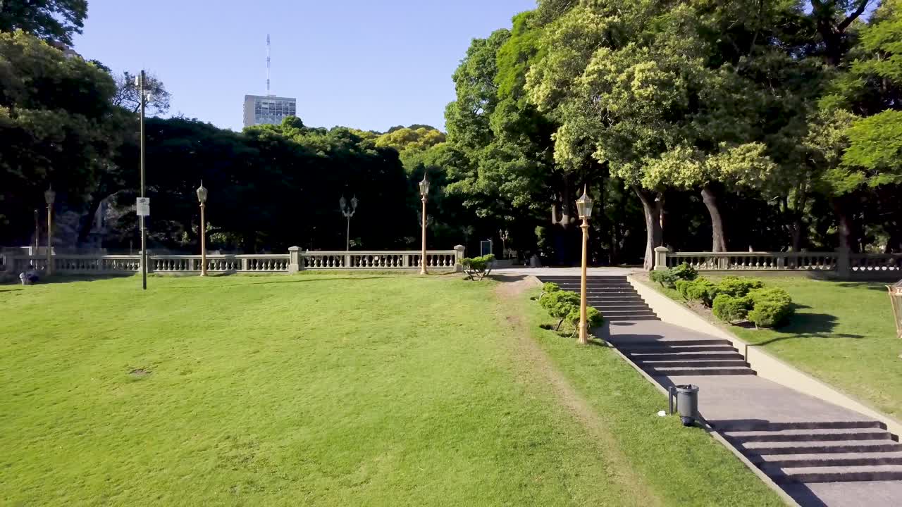 Aerial shot following stairs in Plaza San Martin surrounded by vegetation, Buenos Aires. DOLLY OUT