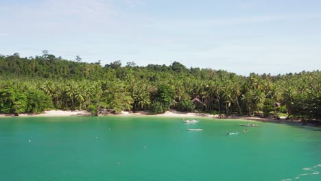 Aerial-parallax-shot-of-boats-anchored-in-green-Indonesian-bay