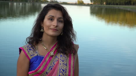 young woman outdoors in front of lake