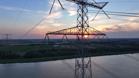 aerial view of high voltage pylon at sunset