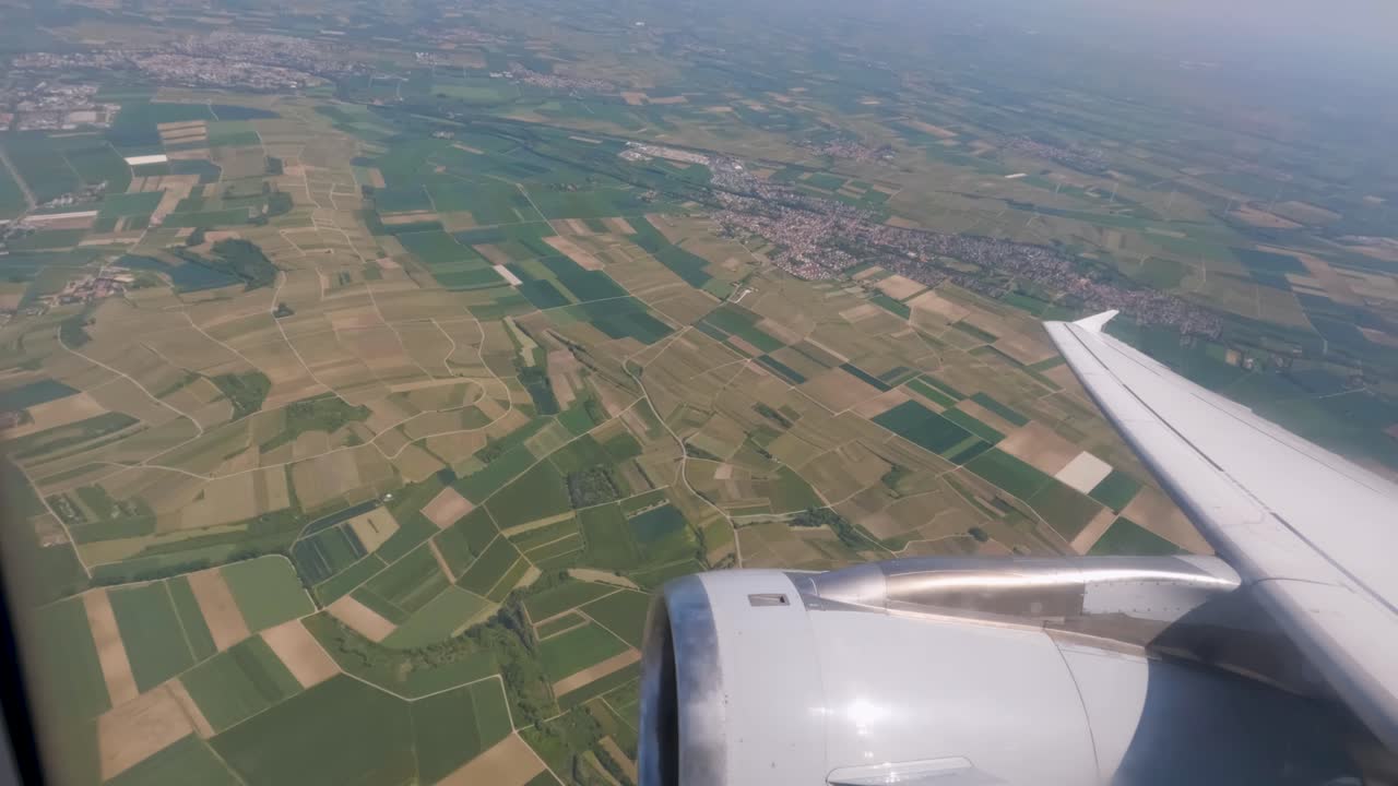 ventanas de avión en vuelo turbina en primer plano volando sobre campos cultivados en alemania