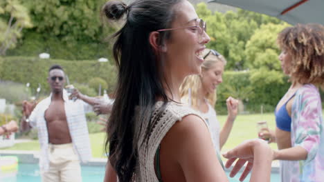 young biracial woman enjoys a pool party outdoors