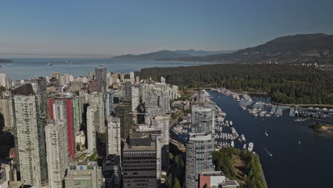 vancouver bc canada aerial v98 establishing shot drone flyover downtown capturing bayshore cityscape of coal harbour, bustling marina and stanley park views - shot with mavic 3 pro cine - july 2023