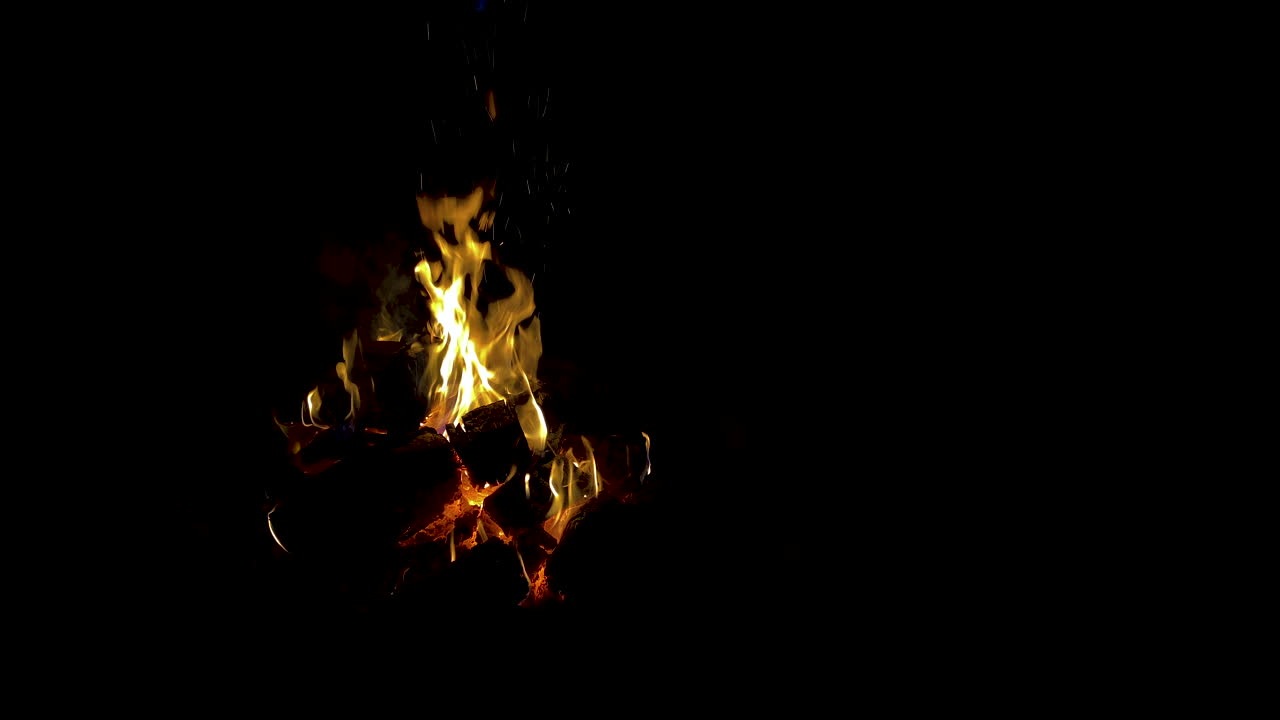 Fire on black background od left side, the symbol of open-air fire at night