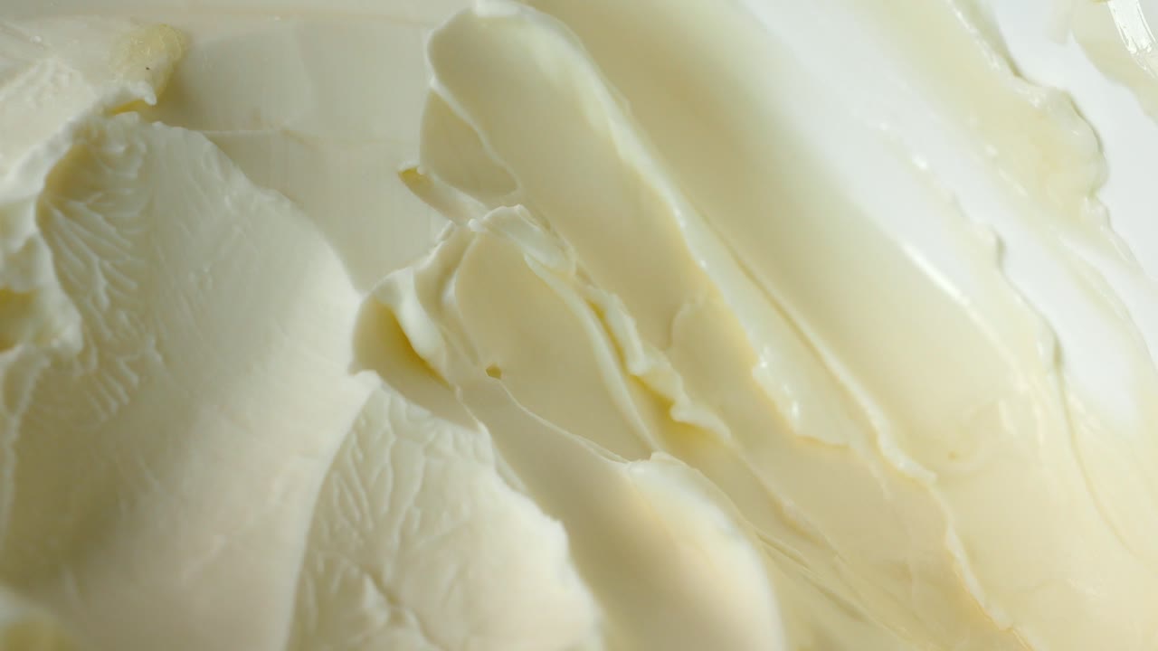 Fresh butter in a container with bread on white background