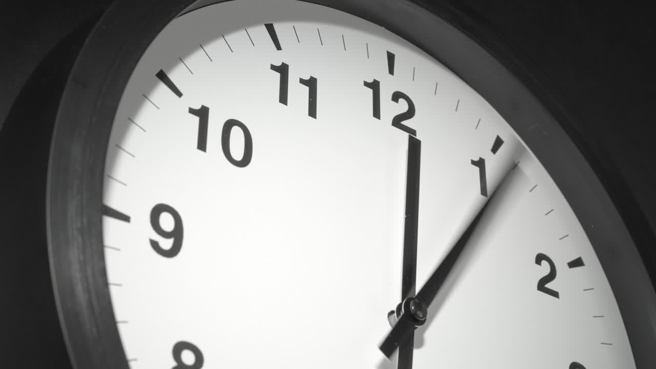 Clock Face in Time Lapse on Dark Grey Wall