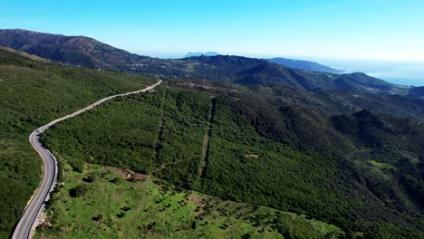 Pano-Green-hills-seen-from-a-drone-on-a-sunny-beautiful-day,-the-Mediterranean-sea-in-the-background