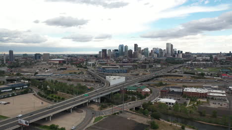 aerial view of freeway traffic outside downtown denver, colorado usa under dramatic sky, drone shot