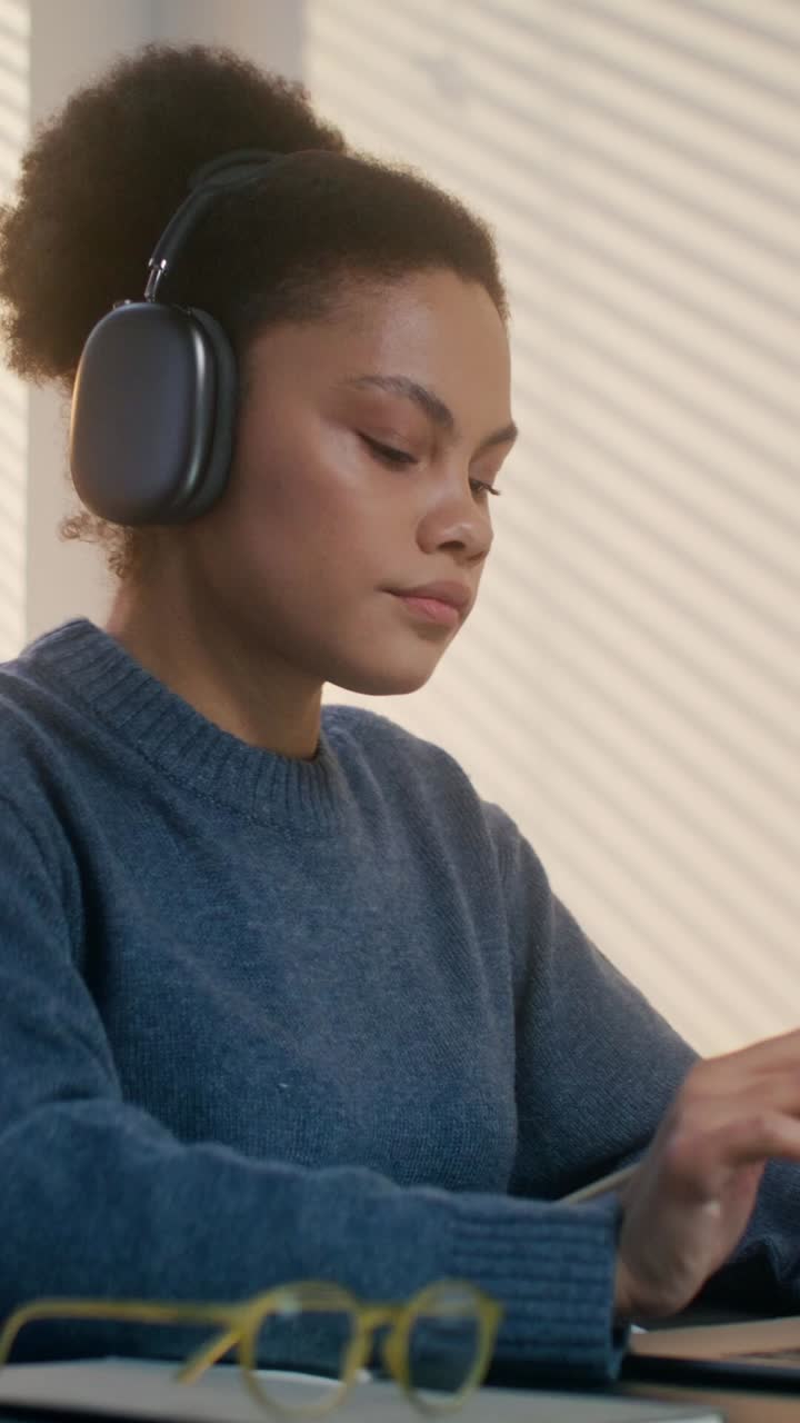 Woman studying with headphones