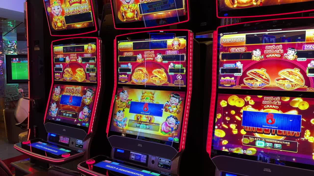 Asian themed casino digital slot machines, red flashing lights, tilting up view