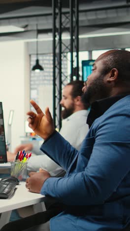 vertical video black analyst meeting on online video call with associates to discuss insights
