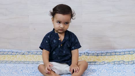 toddler-baby-boy-doing-cute-facial-and-hand-action-at-indoor